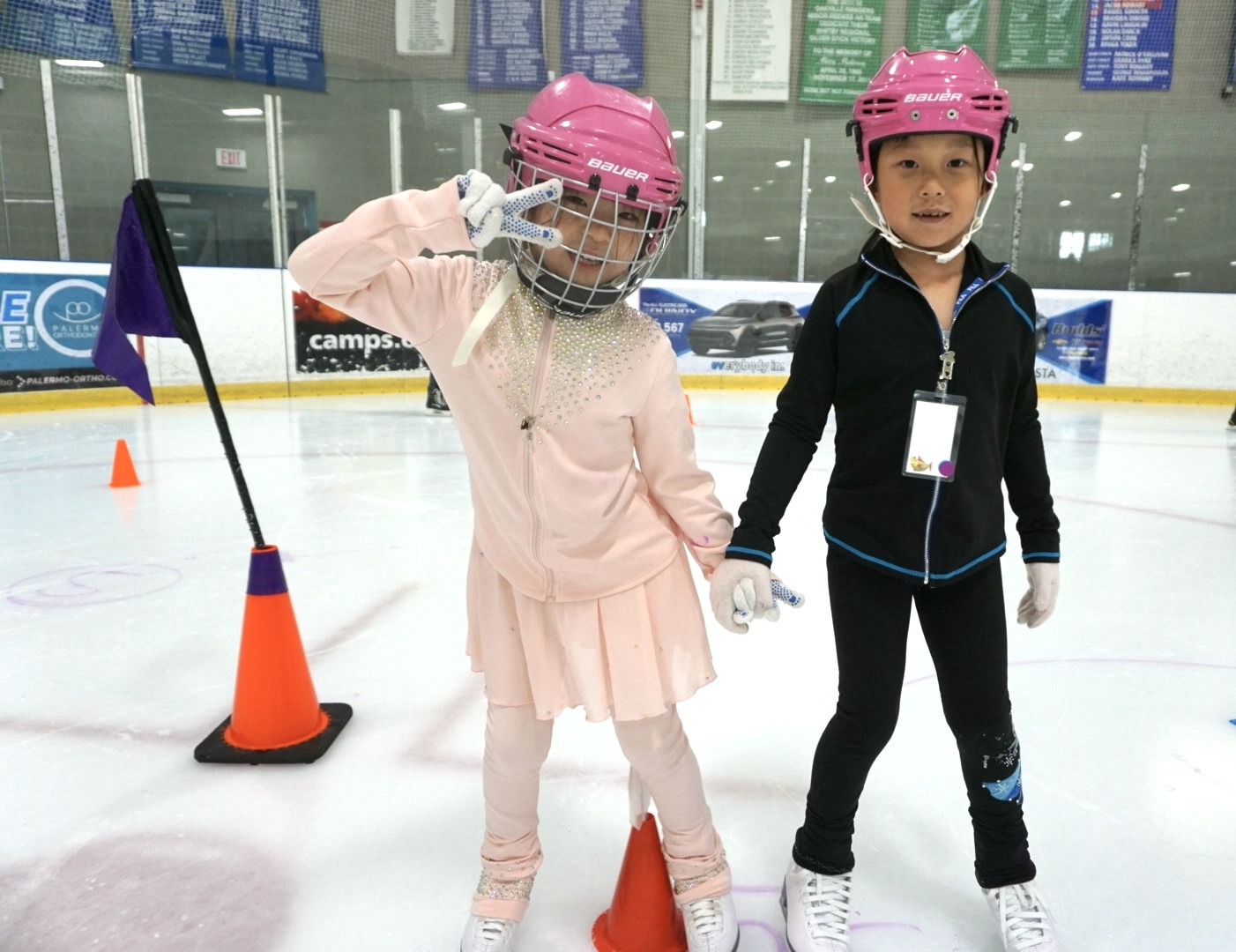 Two young skaters very happy to be on the ice