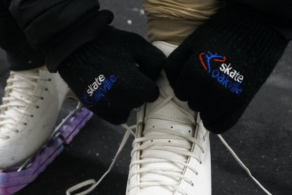 Hands wearing Skate Oakville gloves