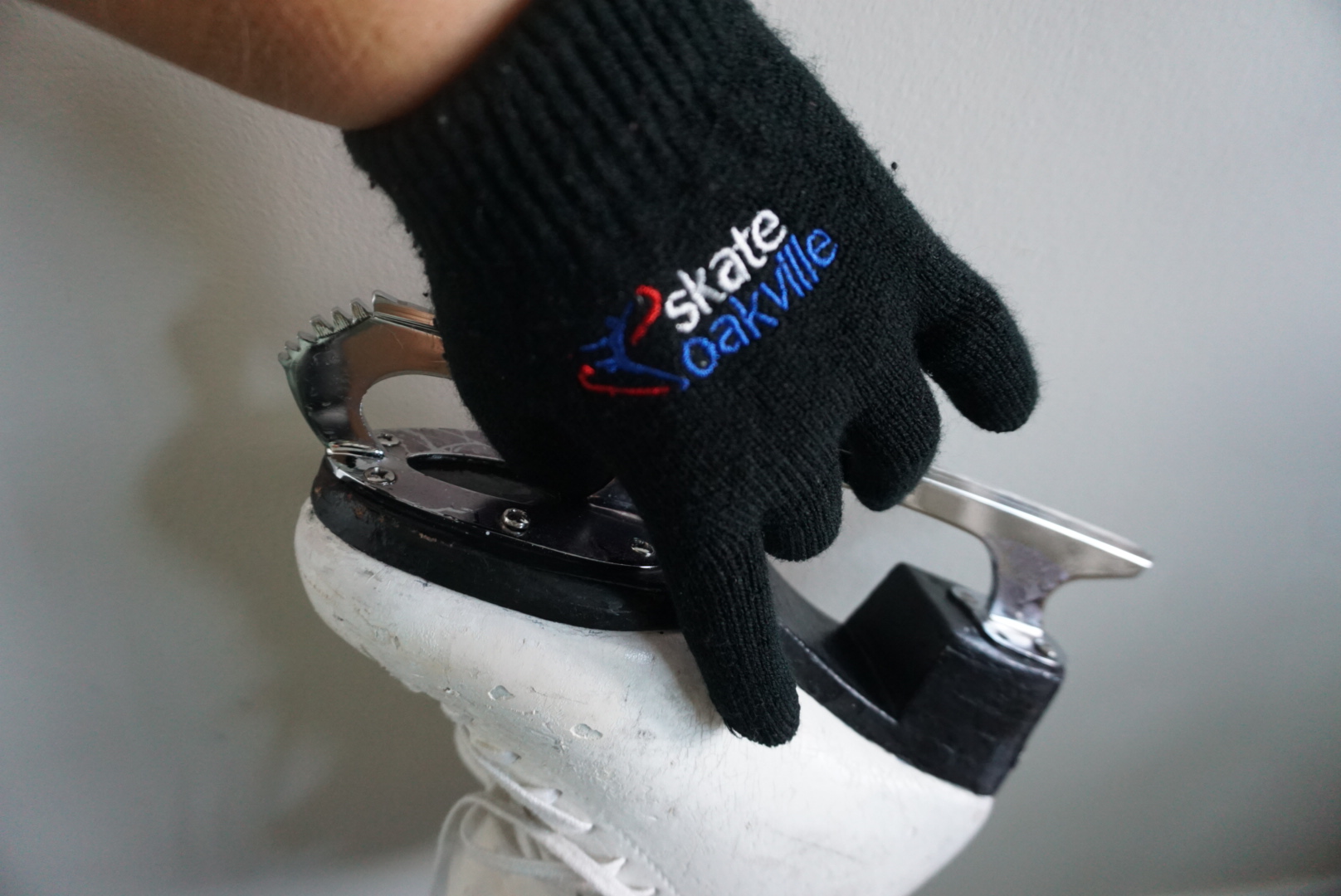 gloved hand holding a skate